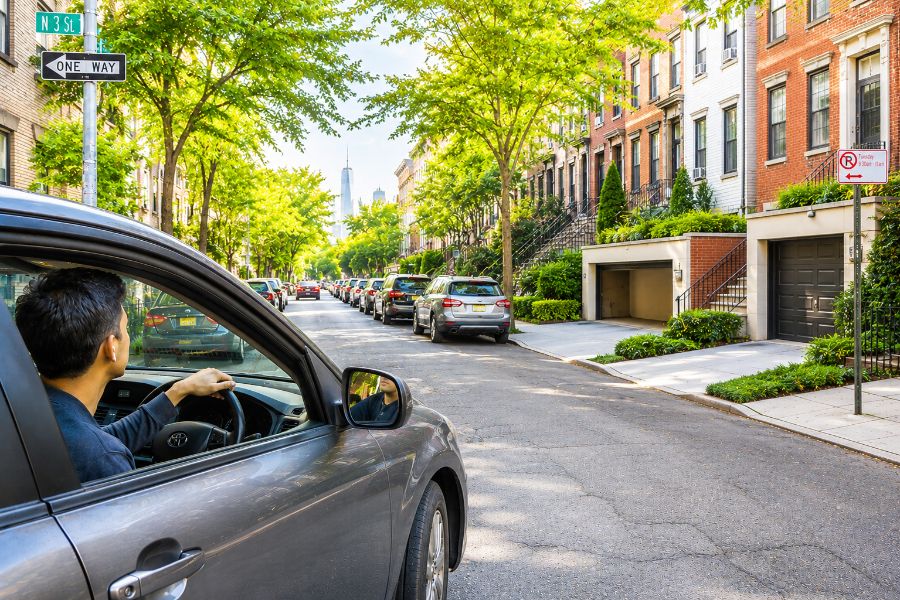 Driver looking for parking on a packed residential street